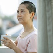 Asian woman outdoors with coffee