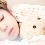 Girl sleeping with stuffed animal