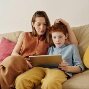 Boy on ipad with mom