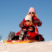 Girls sledding in snow