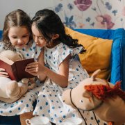 Two girlfriends reading book