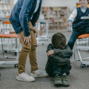 Child with head down in classroom